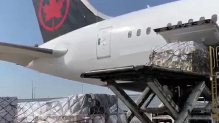 cargo being loaded in back of plane